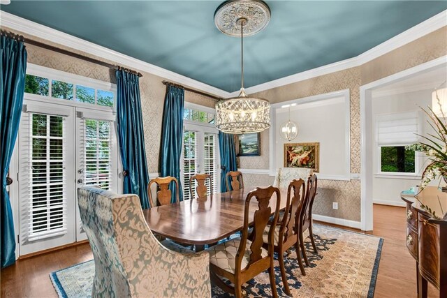 3663 Brookhaven Manor Xing NE, Atlanta, GA 30319 - dining space featuring wallpapered walls, a chandelier, wood finished floors, french doors, and crown molding