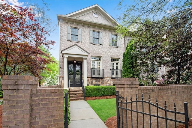 3663 Brookhaven Manor Xing NE, Atlanta, GA 30319 - view of front facade with french doors, brick siding, and a gate