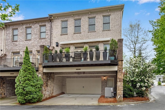 3663 Brookhaven Manor Xing NE, Atlanta, GA 30319 - view of building exterior featuring central AC, a garage, and driveway