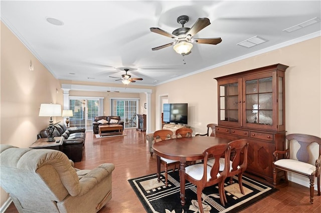 dining area featuring wood-type flooring, ceiling fan, and crown molding