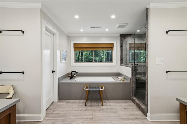 full bathroom with vanity, ornamental molding, visible vents, a bath, and a stall shower