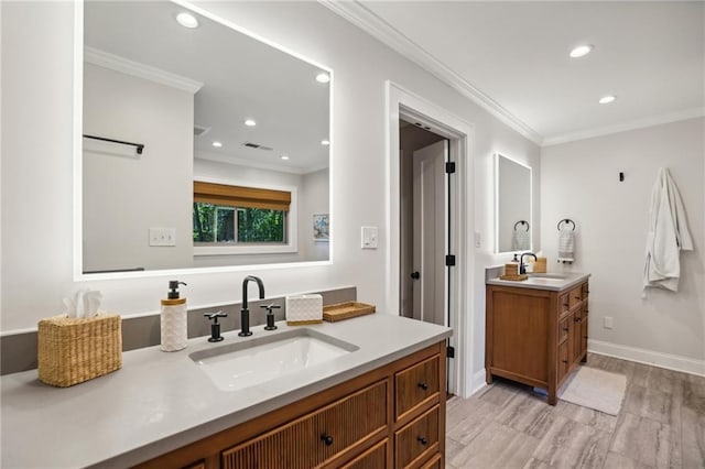 bathroom with a sink, recessed lighting, wood finished floors, and two vanities