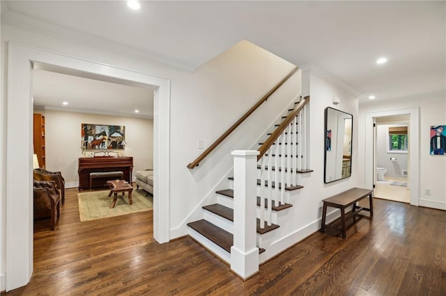 staircase with recessed lighting, baseboards, ornamental molding, and wood finished floors