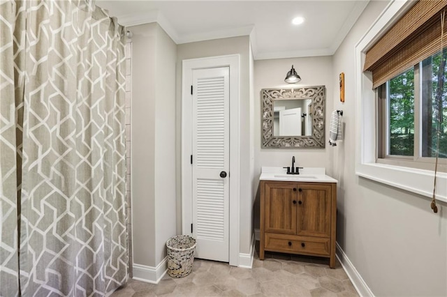 full bathroom with a closet, baseboards, ornamental molding, and vanity