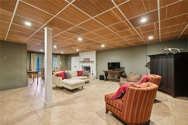 living area with recessed lighting, light tile patterned floors, and a fireplace