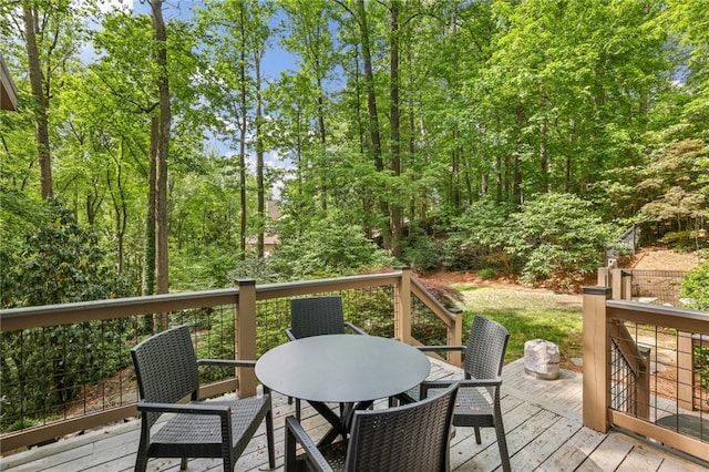 wooden terrace featuring outdoor dining area