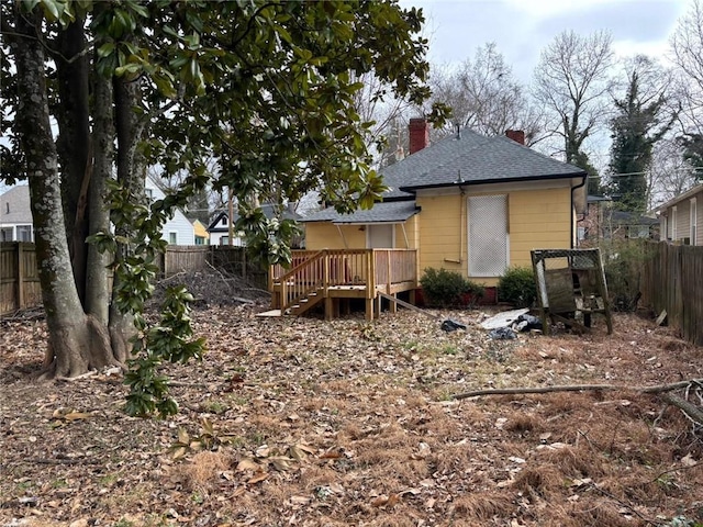 back of house featuring a wooden deck