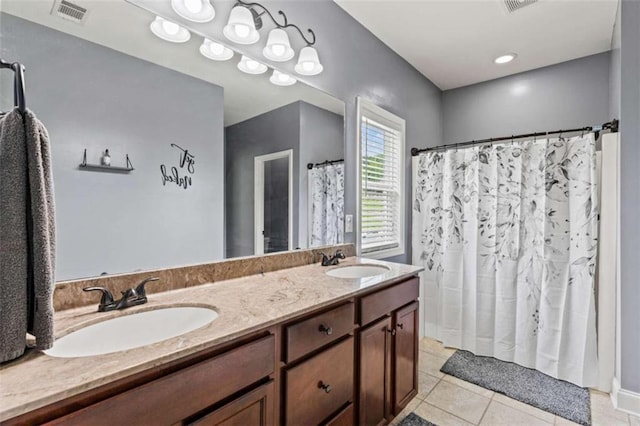 bathroom featuring tile patterned floors, double vanity, and a shower with curtain