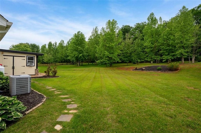 view of green lawn with central AC unit
