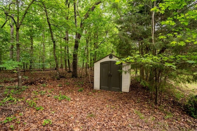 view of shed with a view of trees