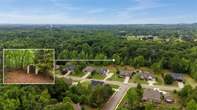aerial view of residential area with a forest and property parcel outlined
