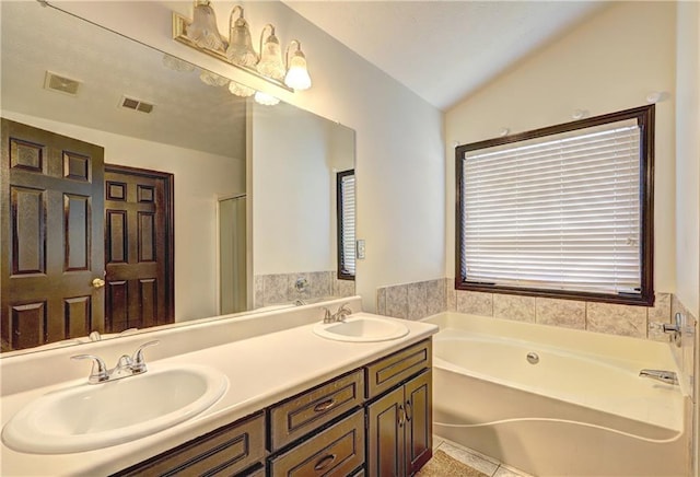 full bathroom featuring a sink, visible vents, and lofted ceiling