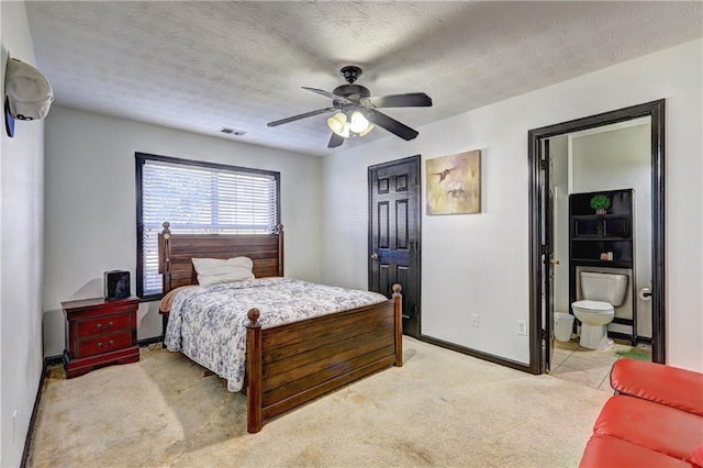 bedroom with visible vents, baseboards, a textured ceiling, and light colored carpet