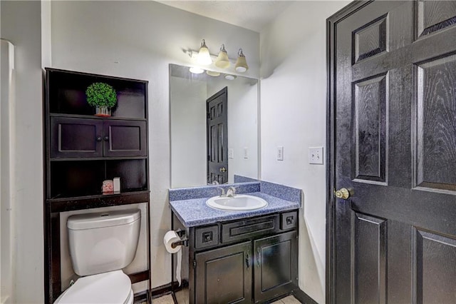 bathroom featuring toilet and vanity