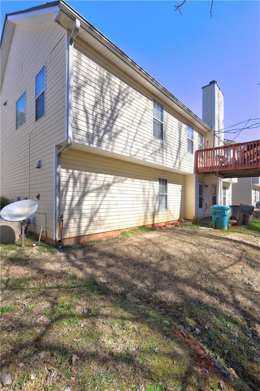 rear view of property featuring a wooden deck