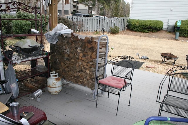 view of patio featuring a wooden deck and an outdoor fire pit