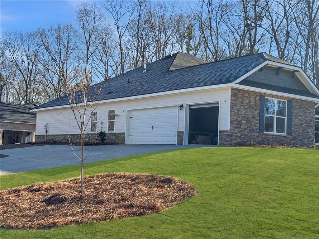 view of property exterior featuring a yard and a garage