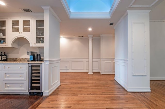4252 Tall Hickory Trl, Gainesville, GA 30506 - indoor bar with beverage cooler, light wood-style flooring, recessed lighting, a wainscoted wall, and ornamental molding