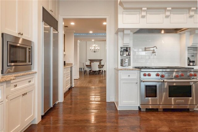 4252 Tall Hickory Trl, Gainesville, GA 30506 - kitchen with high end appliances, white cabinetry, backsplash, dark wood-style flooring, and a chandelier