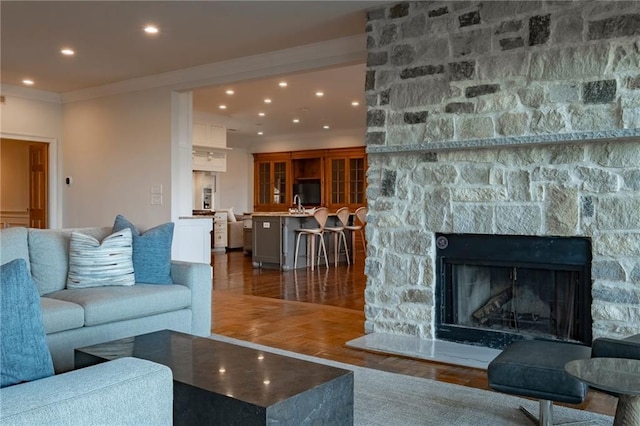 4252 Tall Hickory Trl, Gainesville, GA 30506 - living area featuring wood finished floors, recessed lighting, ornamental molding, and a fireplace