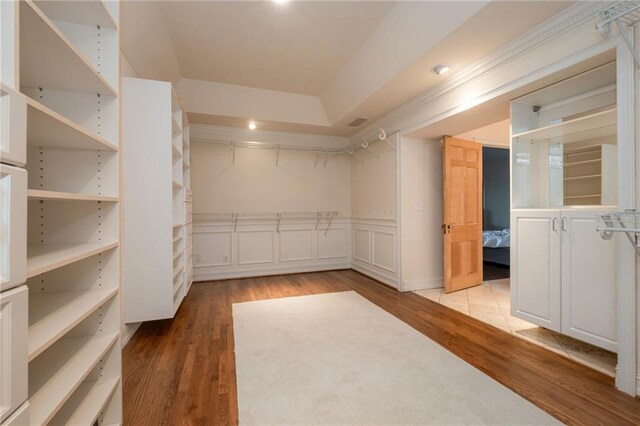 4252 Tall Hickory Trl, Gainesville, GA 30506 - walk in closet featuring wood finished floors and a raised ceiling