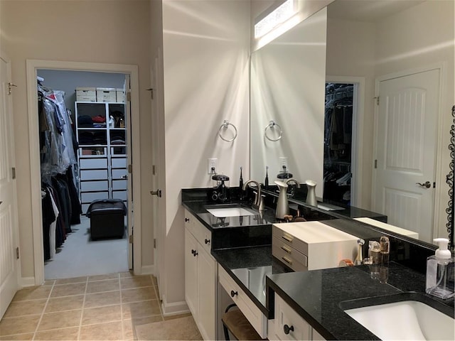 3311 Lindenridge Dr, Buford, GA 30519 - bathroom featuring vanity, baseboards, tile patterned floors, and a spacious closet
