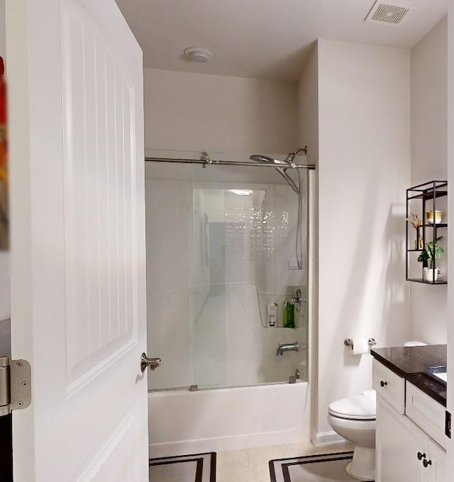 3311 Lindenridge Dr, Buford, GA 30519 - bathroom featuring visible vents, vanity, toilet, tile patterned floors, and combined bath / shower with glass door