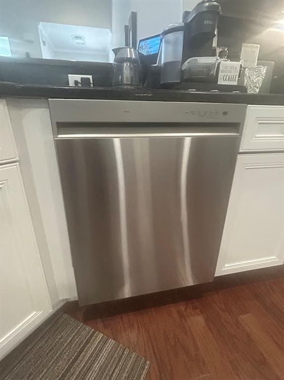3311 Lindenridge Dr, Buford, GA 30519 - room details featuring dark countertops, stainless steel dishwasher, white cabinetry, and dark wood-type flooring