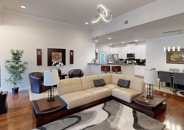 3311 Lindenridge Dr, Buford, GA 30519 - living area with visible vents, wood finished floors, baseboards, ornamental molding, and recessed lighting