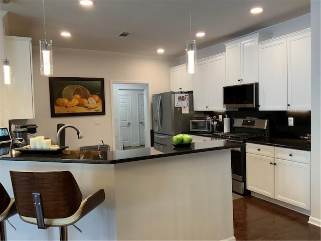 3311 Lindenridge Dr, Buford, GA 30519 - kitchen featuring dark countertops, stainless steel appliances, recessed lighting, and visible vents