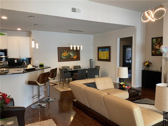 3311 Lindenridge Dr, Buford, GA 30519 - living area with recessed lighting, baseboards, dark wood-type flooring, visible vents, and ornamental molding