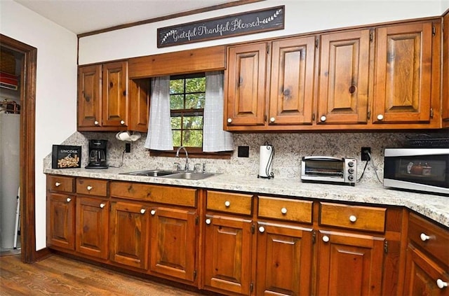 kitchen with tasteful backsplash, sink, ornamental molding, and dark hardwood / wood-style flooring