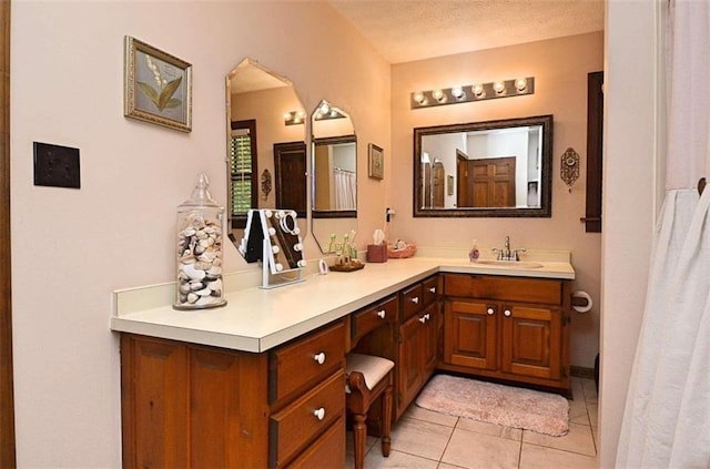 bathroom with tile patterned floors, vanity, and a textured ceiling