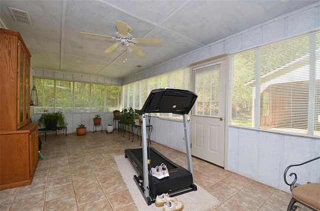 exercise area featuring light tile patterned flooring and ceiling fan