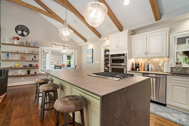 7265 Hunters Branch Dr, Sandy Springs, GA 30328 - kitchen with stainless steel appliances, decorative backsplash, a center island, dark wood-type flooring, and a kitchen bar