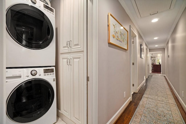 7265 Hunters Branch Dr, Sandy Springs, GA 30328 - laundry area with stacked washer / drying machine, crown molding, attic access, wood finished floors, and baseboards