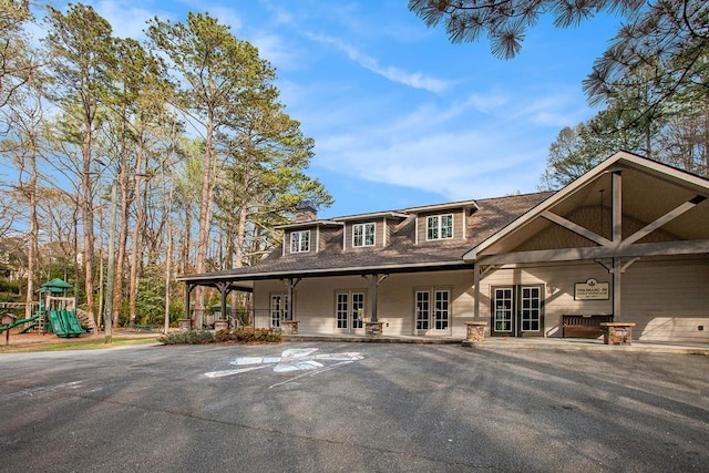 7265 Hunters Branch Dr, Sandy Springs, GA 30328 - view of front of home featuring french doors, a chimney, and a playground