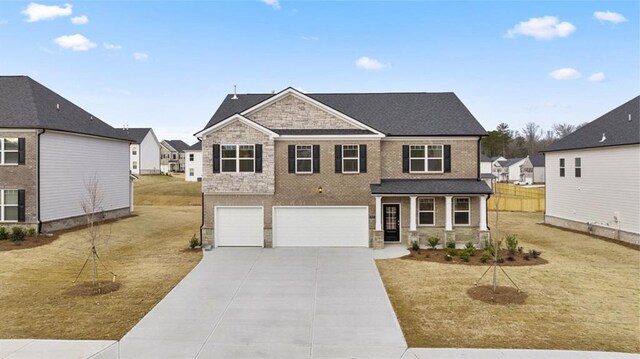 view of front facade featuring a garage and a front lawn