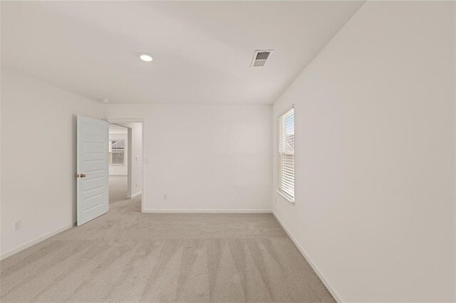 unfurnished room with light colored carpet