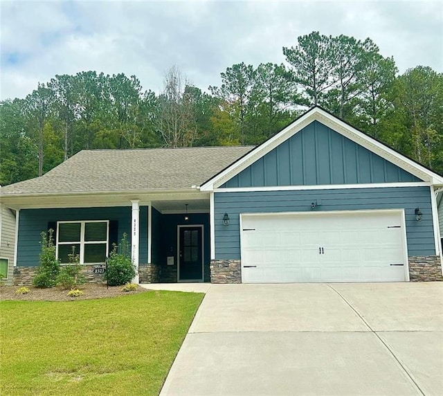 view of front of house with a garage and a front lawn