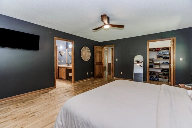 750 Jett Roberts Rd, Jefferson, GA 30549 - bedroom featuring wood finished floors, a spacious closet, ensuite bathroom, baseboards, and a ceiling fan