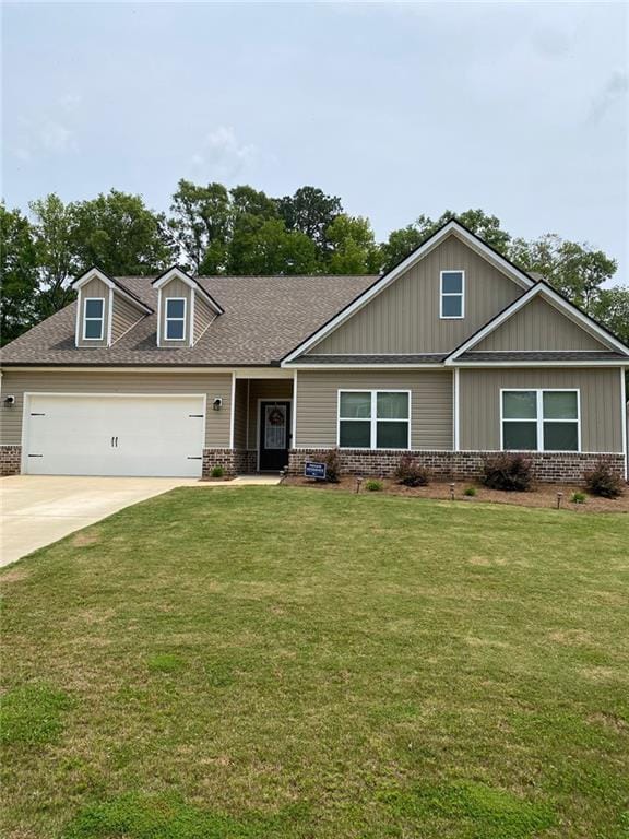 115 Harmony Farms Dr, Eatonton, GA 31024 - craftsman-style house with brick siding, an attached garage, concrete driveway, and a front lawn