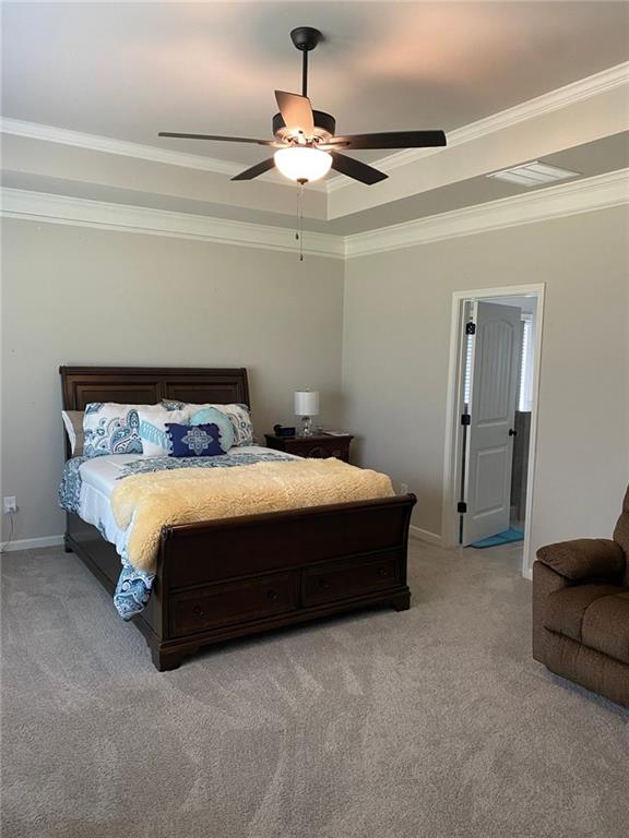 115 Harmony Farms Dr, Eatonton, GA 31024 - bedroom featuring a raised ceiling, light colored carpet, ornamental molding, and ceiling fan