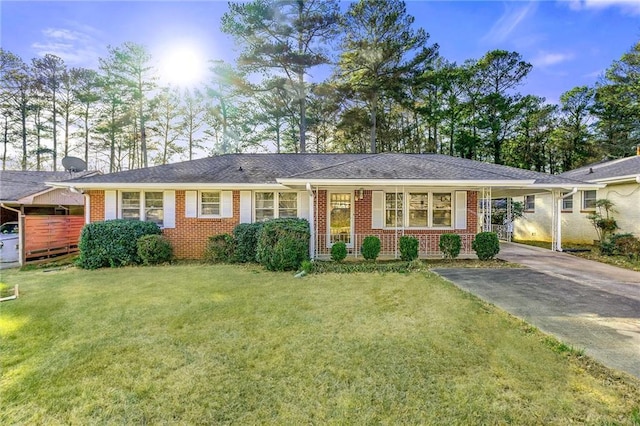 1147 Longshore Dr, Decatur, GA 30032 - ranch-style house with a carport, a front lawn, brick siding, and concrete driveway