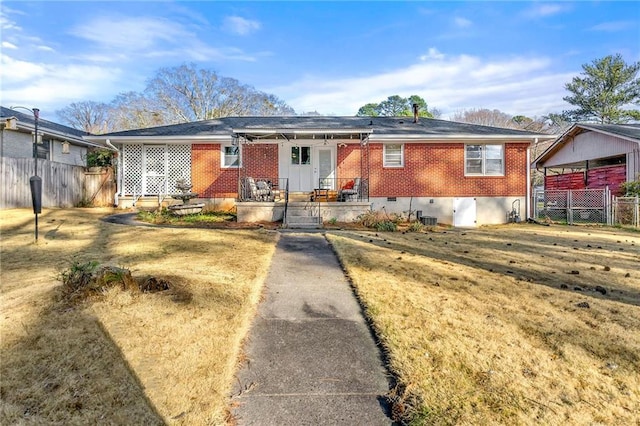 view of front of house with brick siding and fence