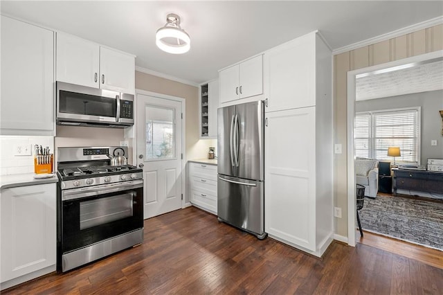 kitchen featuring stainless steel appliances, white cabinets, dark wood-type flooring, and crown molding