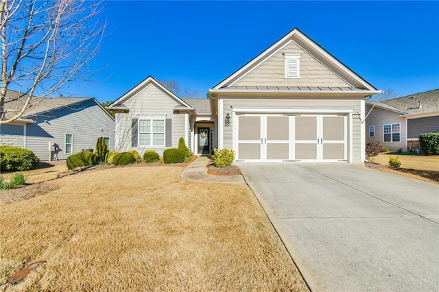 view of front of property with a garage, concrete driveway, and a front lawn