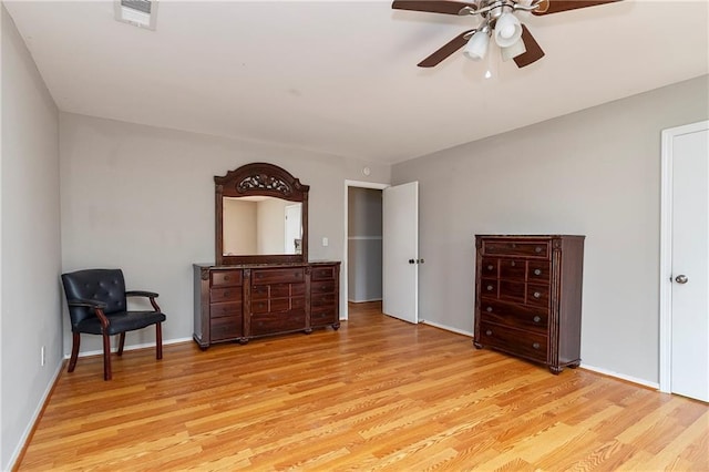 sitting room with visible vents, baseboards, ceiling fan, and wood finished floors