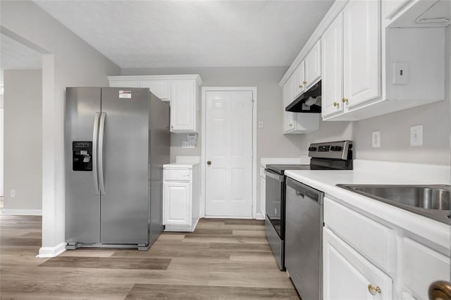 800 Tradd Ct, Stone Mountain, GA 30087 - kitchen with appliances with stainless steel finishes, under cabinet range hood, light wood-style flooring, and white cabinets