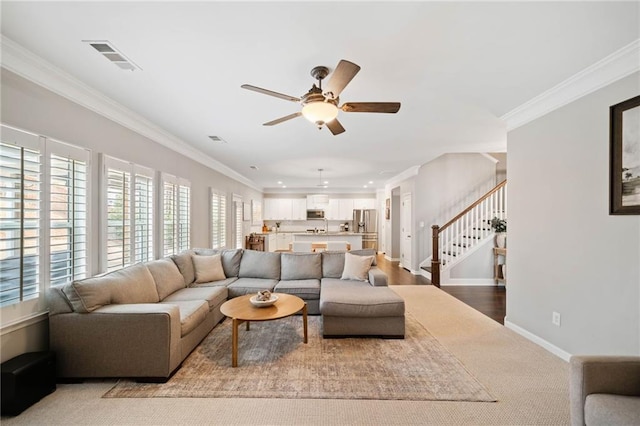 living room with crown molding and ceiling fan